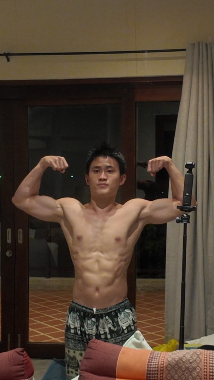 Sean Lim, personal trainer in Singapore, flexing to show a lean, muscular physique.